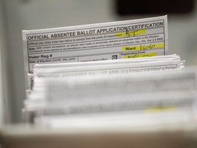 FILE - Absentee ballots are seen during a count at the Wisconsin Center for the midterm election Tuesday, Nov. 8, 2022, in Milwaukee. A federal judge has thrown out a lawsuit brought by Democrats that challenged Wisconsin's witness requirements for absentee voting, a ruling that keeps the law in place with the presidential election six months away. U.S. District Court Judge James Peterson tossed the lawsuit Thursday, May 9, 2024, saying the fact that the law has stood unchallenged in one form or another since the 1960s was "telling."