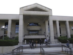 FILE - People gather outside the Nevada Supreme Court in Carson City, May 8, 2018. The Nevada Supreme Court, Monday, May 13, 2024, struck down a proposed ballot initiative that would allow voters to decide whether to repeal the public funding that lawmakers approved last year for a new MLB stadium in Las Vegas.