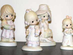 A selection of Precious Moments figurines sit on a shelf, Thursday, May 23, 2024, in Blaine, Minn. Sam Butcher, the artist who created the Precious Moments figurines depicting angelic teardrop-eyed children, died early Monday, May 20, 2024, surrounded by family. He was 85.