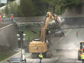 In this photo made from video, a demolition crew begins work on tearing down the Fairfield Avenue bridge, Friday, May 3, 2024, in Norwalk, Conn. Workers have begun removing the bridge over I-95 that was damaged in a fiery crash involving a gasoline tanker truck on Thursday. The demolition is expected to keep both sides of Interstate 95 in Norwalk closed through the weekend. (WABC TV via AP))