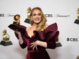 FILE - Adele, winner of the award for best pop solo performance for "Easy on Me," poses in the press room at the 65th annual Grammy Awards on Feb. 5, 2023, in Los Angeles. Artists from Universal Music Group, which include Drake, Adele, Bad Bunny and Billie Eilish, will be returning to TikTok as the two parties have struck a new licensing agreement following an approximately three-month long dispute.