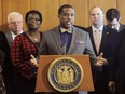 FILE - New York Sen. Kevin Parker, D-Brooklyn, stands at the podium, flanked by Senate members, Feb. 6, 2017, during a news conference at the Capitol in Albany, N.Y. A disability rights advocate made a complaint to New York State Police saying he was shoved twice in the state Capitol building by Parker, a Brooklyn Democrat with a history of violent behavior.