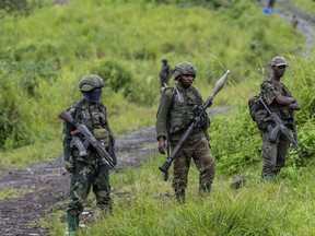 FILE - M23 rebels stand with their weapons in Kibumba, in the eastern of Democratic Republic of Congo, Dec. 23, 2022. M23, a rebel group with alleged links to Rwanda, has seized Rubaya, a mining town in eastern Congo known for producing a key mineral used in smartphones, the group said Thursday, May 2, 2024, in a statement.