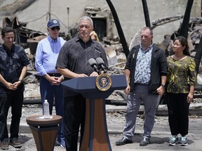FILE - Maui Country Mayor Richard Bissen speaks as Sen. Brian Schatz, D-Hawaii, President Joe Biden, Hawaii Gov. Josh Green and his wife, Jaimie, listen after Biden toured areas devastated by the Maui wildfires, Aug. 21, 2023, in Lahaina, Hawaii. Nine months after the deadliest U.S. wildfire in more than a century struck, Bissen says the county will hire an outside expert to assess how its emergency management agency performed during the disaster.