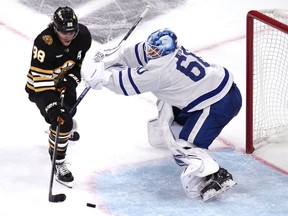 Toronto Maple Leafs goaltender Joseph Woll (60) stops Boston Bruins right wing David Pastrnak (88) during the third period of Game 5 of an NHL hockey Stanley Cup first-round playoff series, Tuesday, April 30, 2024, in Boston.