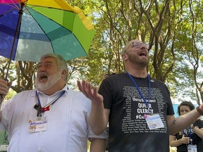 The Rev. David Meredith, left, and the Rev. Austin Adkinson sing during a gathering of those in the LGBTQ community and their allies outside the Charlotte Convention Center, in Charlotte, N.C., Thursday, May 2, 2024. They were celebrating after the General Conference of the United Methodist Church voted to remove the denomination's 52-year-old social teaching that deemed homosexuality "incompatible with Christian teaching."