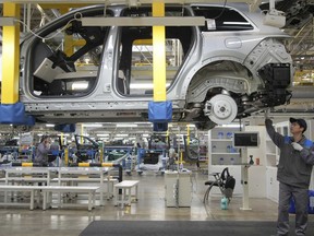 FILE - A worker assembles an SUV at a car plant of Li Auto, a major Chinese EV maker, in Changzhou in eastern China's Jiangsu province on March 27, 2024. The Biden administration is announcing plans to slap new tariffs on Chinese electric vehicles, advanced batteries, solar cells, steel, aluminum and medical equipment. (Chinatopix Via AP, File)