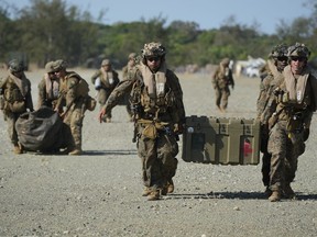 U.S. marines carry equipment at the Paredes Air Station at Pasuquin, Ilocos Norte province during a joint military exercise in northern Philippines on Monday, May 6, 2024. American and Filipino marines held annual combat-readiness exercises called Balikatan, Tagalog for shoulder-to-shoulder, in a show of allied military readiness in the Philippines' northernmost town facing southern Taiwan.