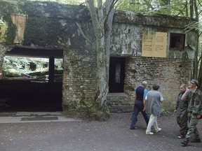 FILE - Tourists visit the ruins of Adolf Hitler's headquarters the "Wolf's Lair" in Gierloz, northeastern Poland, July 17, 2004 where his chief of staff members made an unsuccessful attempt at Hitler's life on July 20, 1944. Polish prosecutors have discontinued an investigation into human skeletons found at Wolf's Lair where German dictator Adolf Hitler and other Nazi leaders spent time during World War II because the advanced state of decay made it impossible to determine the cause of death, a spokesman said Monday, May 6, 2024.