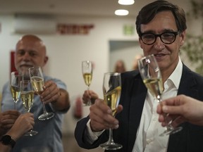 Socialist candidate Salvador Illa makes a toast with members of his team and party colleagues after the announcement of the results of the elections to the Catalan parliament in Barcelona, Sunday May 12, 2024. The Socialists led by former health minister Illa won a majority of 42 seats, up from their 33 seats in 2021 when they also barely won the most votes but were unable to form a government. They will still need to earn the backing of other parties to put Illa in charge.