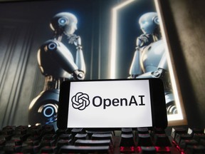 FILE - The OpenAI logo is seen displayed on a cell phone with an image on a computer monitor generated by ChatGPT's Dall-E text-to-image model, Friday, Dec. 8, 2023, in Boston. A former OpenAI leader who resigned from the company earlier this week said on Friday that product safety has "taken a backseat to shiny products" at the influential artificial intelligence company.