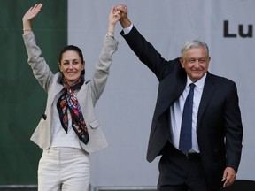FILE - Mexico's President Andres Manuel Lopez Obrador, right, and then Mayor Claudia Sheinbaum, greet supporters at a rally in Mexico City's main square, the Zocalo, July 1, 2019. Sheinbaum, Mexico's ruling party presidential candidate, slipped up during a campaign speech Friday, May 10, 2024, and said López Obrador was motivated by "personal ambition," but later acknowledged the phrase "could be misinterpreted." In Mexico it is used to describe a desire for personal economic gain.