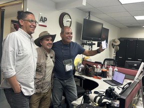 AP photographers, from left, Eduardo Verdugo, Marco Ugarte and Fernando Llano pose for photos after winning the Pulitzer for feature photography, for their images of the migration crisis, at the Associated Press office in Mexico City, Monday, May 6, 2024. Eight AP staff and freelance photographers, six from Latin America and two from the U.S., were awarded this year's Pulitzer for feature photography for images taken in 2023 that documented the anxiety, heartbreak and even the brief moments of joy that mark the migrants' journey.