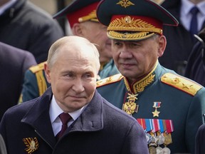 Russian President Vladimir Putin, left and Russian Defense Minister Sergei Shoigu, right, leave Red Square after the Victory Day military parade in Moscow, Russia, Thursday, May 9, 2024, marking the 79th anniversary of the end of World War II.