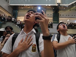 FILE - Local residents sing a theme song written by protesters "Glory to Hong Kong" at a shopping mall in Hong Kong on Sept. 11, 2019. An appeals court Wednesday, May 8, 2024 granted the Hong Kong government's request to ban a popular protest song, overturning an earlier ruling and deepening concerns over the erosion of freedoms in the once-freewheeling global financial hub.