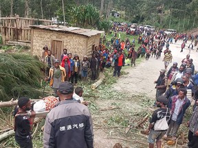 In this photo provided by the International Organization for Migration, an injured person is carried on a stretcher to seek medical assistance after a landslide in Yambali village, Papua New Guinea, Friday, May 24, 2024. More than 100 people are believed to have been killed in the landslide that buried a village and an emergency response is underway, officials in the South Pacific island nation said. The landslide struck Enga province, about 600 kilometers (370 miles) northwest of the capital, Port Moresby, at roughly 3 a.m., Australian Broadcasting Corp. reported.