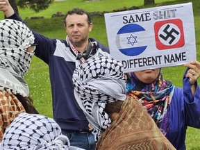 A swastika is displayed by an anti-Israel protester during the Walk With Israel in Toronto on June 9.