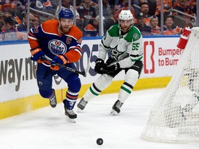 The Edmonton Oilers' Connor McDavid (97) battles the Dallas Stars' Thomas Harley (55) during third period NHL playoff action at Rogers Place, in Edmonton Wednesday May 29, 2024. The Oilers won 5-2.