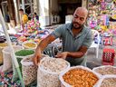 A vendor lays out his merchandise of dried fruit, nuts and seeds at a market in Gaza City on June 15.