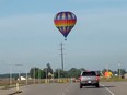 This photo provided by Debbie Wajvoda shows a hot air balloon crashing after hitting a utility pole on Sunday, east of Lowell, Ind.