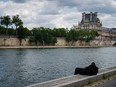 A man rests on the banks of the River Seine in Paris on June 12, 2024.