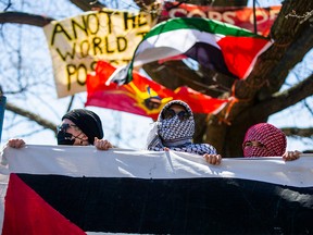 Protesters are seen at the entrance to the anti-Israel encampment at the University of Toronto's downtown campus