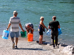 Calgarians collect their own water from the Bow river on Sunday