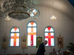An elderly man pauses before Sunday service at St. George's Ukrainian Orthodox Church