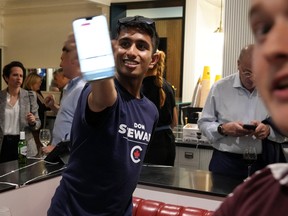A Conservative supporter shows voting results on his phone at an Federal byelection election night event for Toronto—St.Paul's candidate Don Stewart in Toronto, on Monday, June 24, 2024.