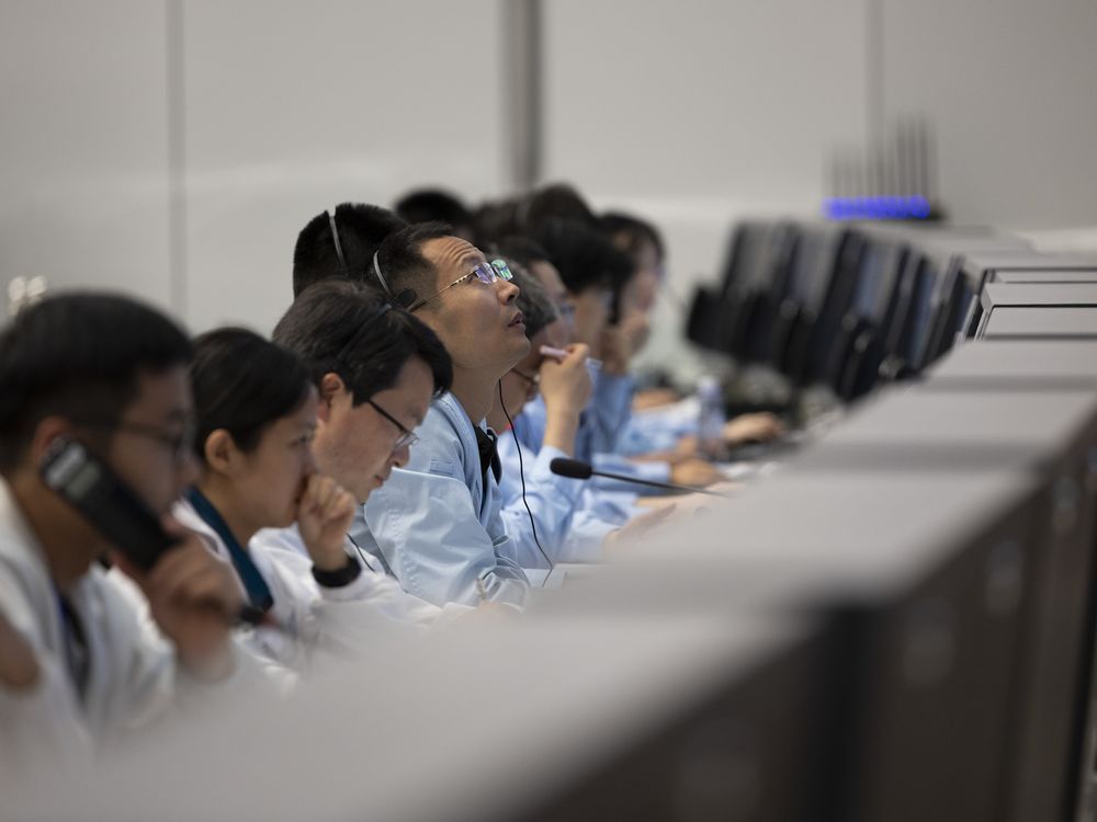 In this photo released by Xinhua News Agency, technical personnel work at the Beijing Aerospace Control Center (BACC) in Beijing, Sunday, June 2, 2024. A Chinese spacecraft landed on the far side of the moon Sunday to collect soil and rock samples that could provide insights into differences between the less-explored region and the better-known near side.