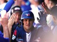 Toronto Blue Jays' Daulton Varsho (25) celebrates in the dugout after hitting a grand slam against the Cleveland Guardians during fifth inning American League MLB baseball action in Toronto on Sunday, June 16, 2024.