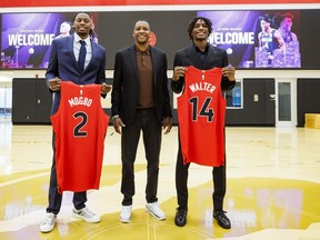Toronto Raptors draft picks Jonathan Mogbo, left, and Ja'Kobe Walter, pose with Toronto Raptors president Masai Ujiri following a press conference at the OVO Athletic Centre in Toronto, Friday, June 28, 2024.