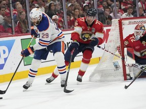 Edmonton Oilers centre Leon Draisaitl (29) skates with the puck as Florida Panthers defenceman Niko Mikkola (77) defends during the third period of Game 7 of the NHL hockey Stanley Cup Final, Monday, June 24, 2024, in Sunrise, Fla.