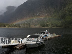 Fishing boats are docked as a rainbow forms over the village of Zeballos, B.C., on Tuesday, April 9, 2024. A cool and wet spring in parts of British Columbia has helped suppress fire activity so far this year, but a forecasted turn in the weather will likely renew wildfire risk this summer.