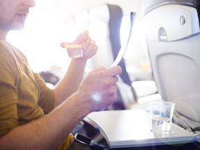 Man drinking water on plane