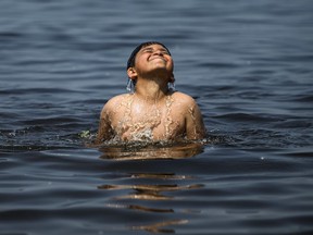 Moaaz, 9, emerges from the waters of the Ottawa River at Britannia Beach in Ottawa, Tuesday, June 18, 2024.THE CANADIAN PRESS/Justin Tang