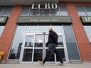 A person walks past an LCBO in Ottawa. Employees have voted overwhelmingly in favour of strike action.