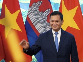FILE - Cambodian Prime Minister Hun Manet poses for photo, in Hanoi, Vietnam on Dec.11, 2023. A court in Cambodia has formally charged a real estate entrepreneur holding a royally bestowed title with the premeditated murder of a young couple in the capital Phnom Penh, a case that has sparked widespread public outrage. The case attracted massive attention largely because the suspect held the title of Oknha, an honorific bestowed on business people who donate large sums of money to the government.