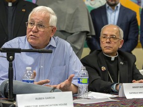 FILE - Ruben Garcia, founder and director of Annunciation House, a network of migrants shelters in El Paso, Texas, speaks during a news conference accompanied by Bishop Mark Seitz, Friday, Feb. 23, 2024. Government officials would be infringing on religious freedom if they were to restrict the Catholic Church's work serving migrants along the U.S.-Mexico border, says a top U.S. bishop.