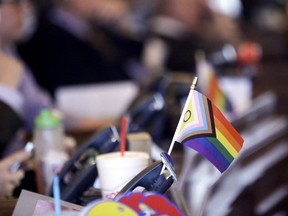 FILE - A flag supporting LGBTQ+ rights decorates a desk on the Democratic side of the Kansas House of Representatives during a debate, March 28, 2023, at the Statehouse in Topeka, Kan. The U.S. Supreme Court agreed Monday to consider whether a Tennessee ban on gender-affirming care for minors is constitutional.