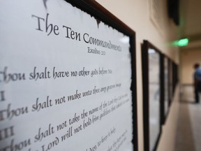 FILE - A copy of the Ten Commandments is posted along with other historical documents in a hallway of the Georgia Capitol, Thursday, June 20, 2024, in Atlanta. Christians and Jews believe in the Ten Commandments -- just not necessarily the version that will hang in every public school and state-funded college classroom in Louisiana.