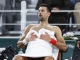 Serbia's Novak Djokovic catches his breath during a changeover in his third round match of the French Open tennis tournament against Italy's Lorenzo Musetti at the Roland Garros stadium in Paris, Sunday, June 2, 2024.