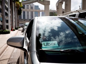 An Uber sticker is seen on a car windshield on the street in downtown Miami on January 9, 2020.