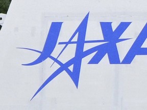 FILE - The logo of the Japan Aerospace Exploration Agency, or JAXA, is seen at its Tanegashima Space Center in Minamitanecho, Kagoshima prefecture, Feb. 16, 2024. Japan's space agency said Friday, June 28, 2024 its planned launch this weekend of a satellite on its new flagship H3 rocket will be postponed until Monday due to expected bad weather. (Kyodo News via AP, File)
