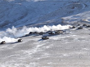 FILE - In this file photo provided by the Indian Army, tanks pull back from the banks of Pangong Tso lake region, in Ladakh along the India-China border on Feb. 10, 2021. Five Indian soldiers were killed when a military tank they were travelling in sank while crossing a river in the remote region of Ladakh that borders China, Defense Minister Rajnath Singh said Saturday, June 29, 2024. (Indian Army via AP, File)