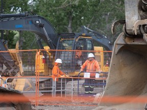 Workers and machinery are seen at the site of a major water pipeline break on 16 Avenue NW in Calgary on Saturday, June 15, 2024.