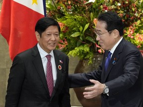 FILE - Japan's Prime Minister Fumio Kishida, right, greets Philippines' President Ferdinand Marcos Jr., prior to their bilateral meeting at the prime minister's official residence in Tokyo, Sunday, Dec. 17, 2023, on the sidelines of the Commemorative Summit for the 50th Year of ASEAN-Japan Friendship and Cooperation. Top defense and foreign affairs officials of Japan and the Philippines will meet in Manila July 2024, to strengthen strategic ties and discuss regional concerns, the Department of Foreign Affairs said Friday June 28, 2024 at a time of escalating alarm over China's increasingly aggressive actions in the disputed South China Sea.