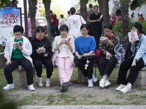 Students review their exam preparation materials in the last minutes before the National College Entrance Exam, or Gaokao, outside an exam venue in Hai'an city in east China's Jiangsu province Friday, June 7, 2024. A 17-year-old vocational school student from rural China in Jiangsu province has become a celebrity on Chinese social media after getting into the final round of a math competition, beating many others from elite universities while raising questions about the education system. . (Chinatopix via AP)
