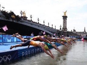 Olympians reportedly reaching for soft drinks after swimming the Seine Olympians reportedly reaching for soft drinks after swimming the Seine