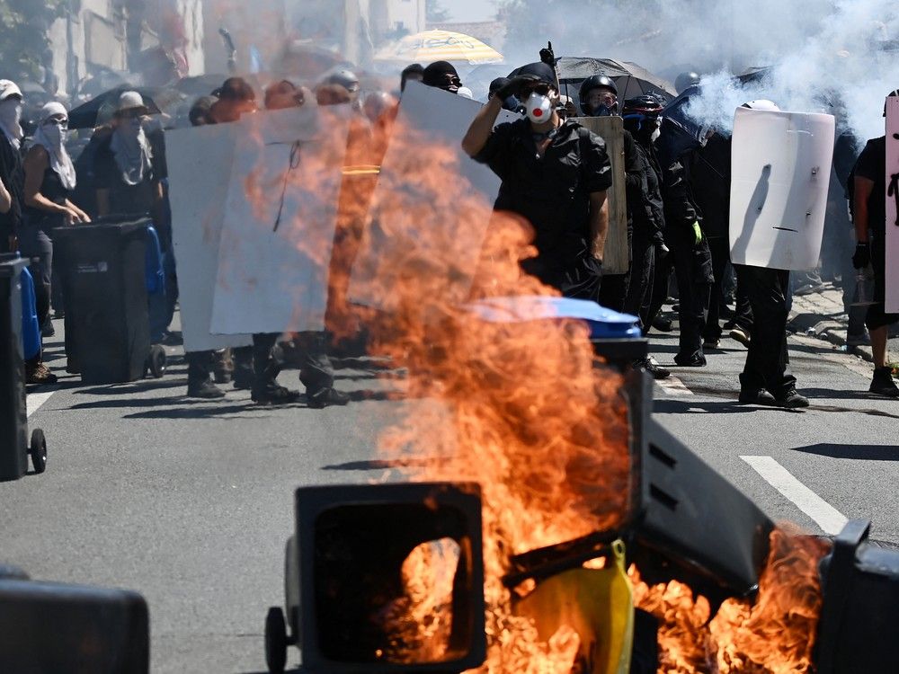 NextImg:Protesters throw projectiles, police fire tear gas grenades in clash after French port blockade